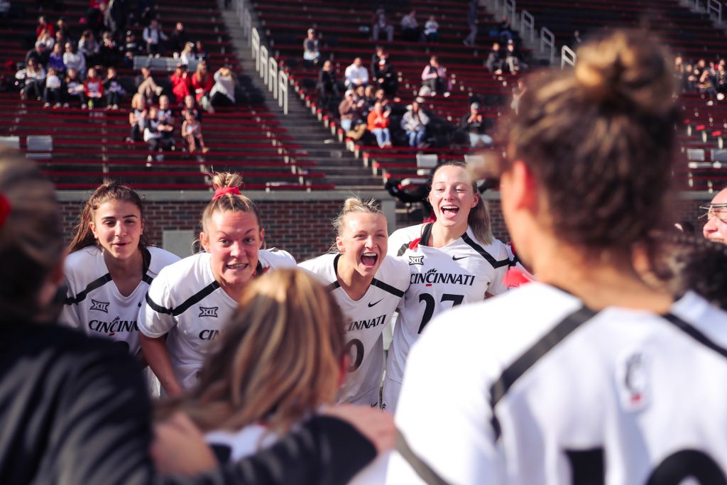 College lacrosse division I team celebrating at halftime.